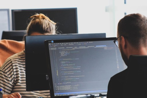 Virtual Assistant Services: woman in black shirt sitting beside black flat screen computer monitor